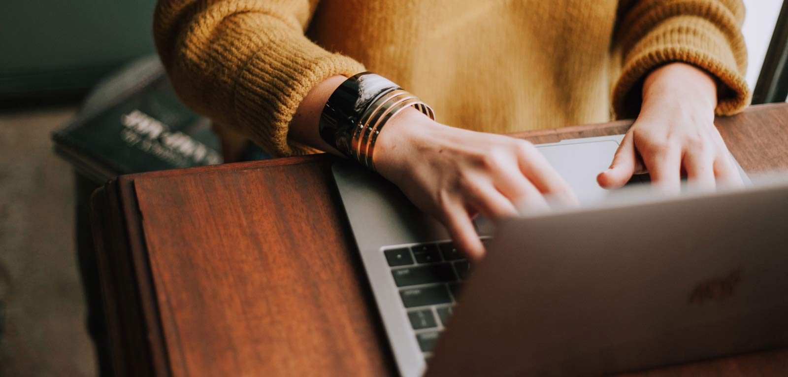 Photo of hands typing on a laptop